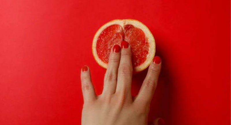 mano tocca arancia con le dita come eufemismo della masturbazione femminile